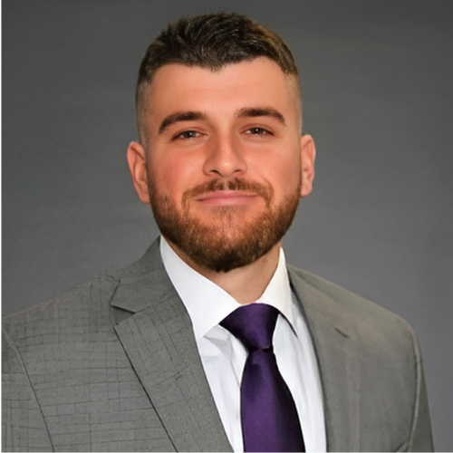 A man in a suit and tie standing up.